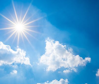 Sunny background, blue sky with white clouds and sun