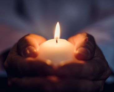 Man holding a burning candle