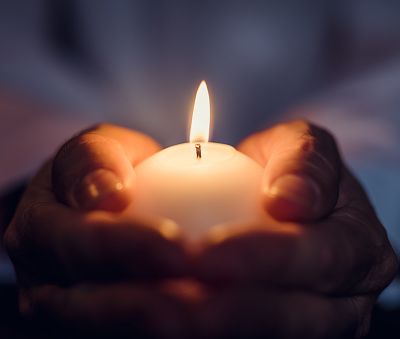 Man holding a burning candle